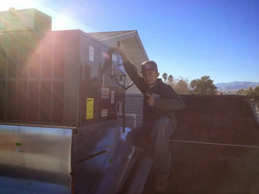 HVAC technician performing HVAC Inspection on a rooftop unit in Northwood